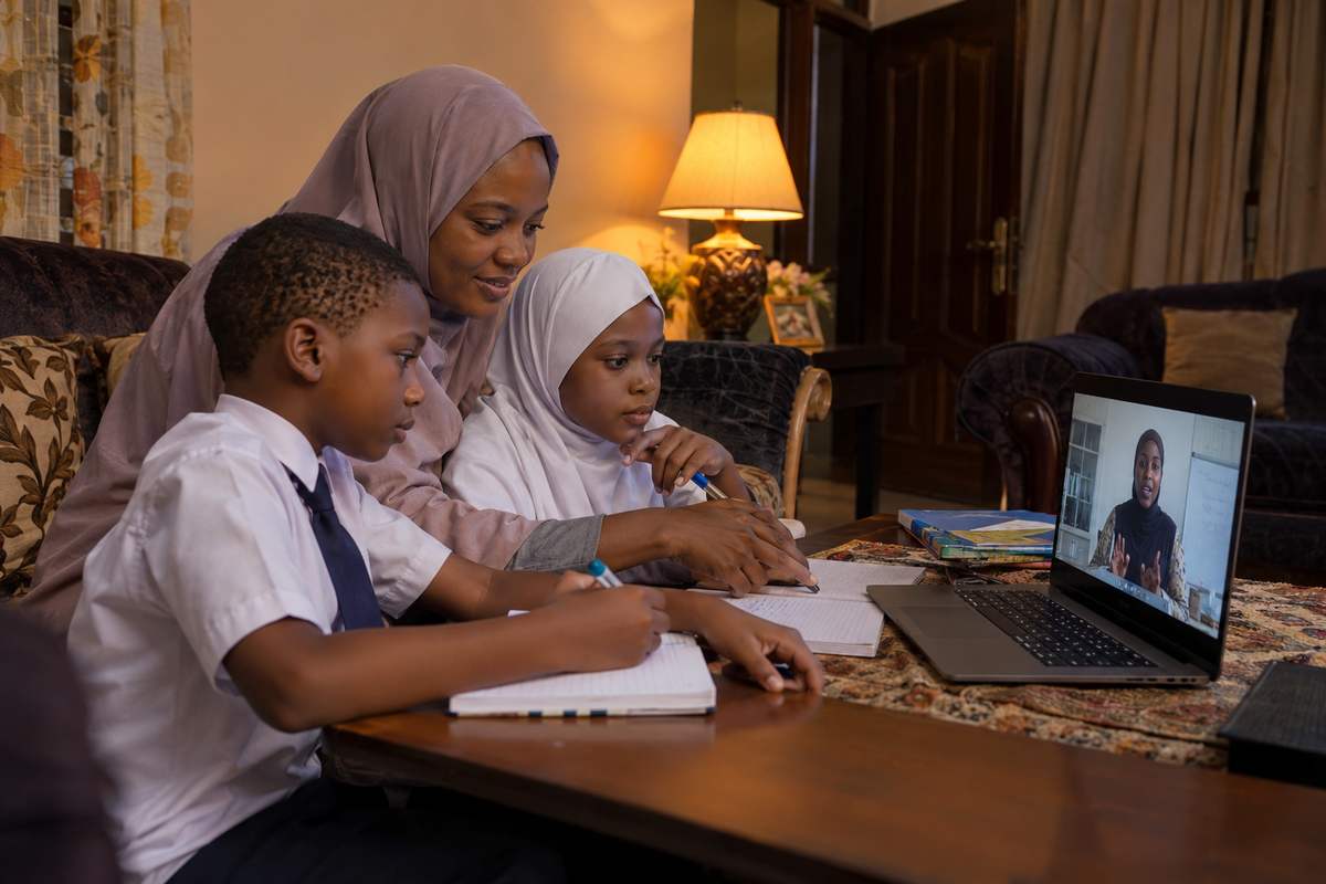 A mother and her two children attending a Adamawa Virtual Academy class online from home
